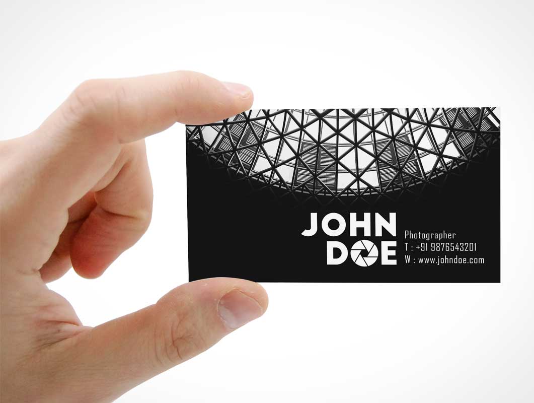Free Business Card Front Held In Hand PSD Mockup
